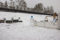 Beautiful view of exterior of small garden with funny snowman in winter day.