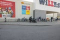 Beautiful view of facade of Willy:s supermarket with people entering and leaving it.