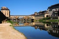 A Beautiful view of the famous Old Bridge Ponte Vecchio and Uffizi Gallery with blue sky in Florence as seen from Arno Royalty Free Stock Photo