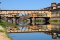 A Beautiful view of the famous Old Bridge Ponte Vecchio and Uffizi Gallery with blue sky in Florence as seen from Arno Royalty Free Stock Photo