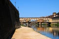 A Beautiful view of the famous Old Bridge Ponte Vecchio and Uffizi Gallery with blue sky in Florence as seen from Arno Royalty Free Stock Photo