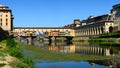 A Beautiful view of the famous Old Bridge Ponte Vecchio and Uffizi Gallery with blue sky in Florence as seen from Arno river Royalty Free Stock Photo