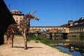 A Beautiful view of the famous Old Bridge Ponte Vecchio and Uffizi Gallery with blue sky in Florence as seen from Arno Royalty Free Stock Photo