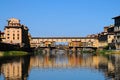 A Beautiful view of the famous Old Bridge Ponte Vecchio and Uffizi Gallery with blue sky in Florence as seen from Arno Royalty Free Stock Photo