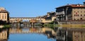 A Beautiful view of the famous Old Bridge Ponte Vecchio and Uffizi Gallery with blue sky in Florence as seen from Arno river Royalty Free Stock Photo