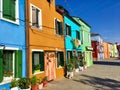 A beautiful view of the famous streets lined with colourful homes in the town of Burano, Italy on a beautiful morning.