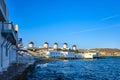 Beautiful view of famous traditional white windmills on hill top, Mykonos, Greece. Whitewashed houses, summer, morning