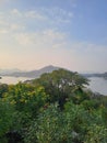 Beautiful view of Fateh Sagar Lake behind trees Royalty Free Stock Photo