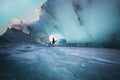 Beautiful view of female in dress posing in the glacier cave in Hofn, Iceland