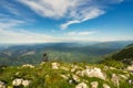 Beautiful view of a female sitting on the rocks in Angliru Peak, Asturias Royalty Free Stock Photo