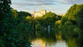 Beautiful view of the Ferris wheel, river, and trees in St James park in London, The UK