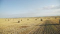 Beautiful view of field with haycocks at spacious horizon and amazing bright sky