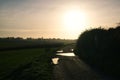 Beautiful view of a field and small puddles at sunset in Plancenoit, Belgium