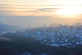 A beautiful view of the filling of the winter morning fog on the landscape of houses. Landscapes top view at sunset in