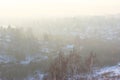 A beautiful view of the filling of the winter morning fog on the landscape of houses. Landscapes top view at sunset in