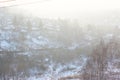 A beautiful view of the filling of the winter morning fog on the landscape of houses. Landscapes top view at sunset in