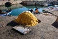 Beautiful view of a fishmen cleaning net on the ground in harbor Royalty Free Stock Photo