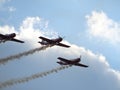 Beautiful view of flying planes performing acrobatic stunts in the sky with smoke at an air show