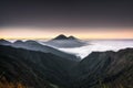 Beautiful View Fog Covers Mount Sindoro Sumbing. View from the top of Bismo Hill when golden hours