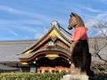 Beautiful view of a fox statue in the Fushimi Inari Shrine Japan Royalty Free Stock Photo