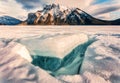 Frozen Lake Minnewanka with rocky mountains and cracked ice from the lake in winter at Banff national park Royalty Free Stock Photo