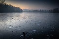 Beautiful view on a frozen lake in winter season in beautiful sunset and mountains Royalty Free Stock Photo