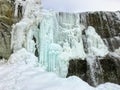 A beautiful view of a frozen waterfall at Wapta Falls with the Rocky Mountains in the background, in Yoho National Park Royalty Free Stock Photo