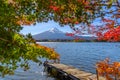 Beautiful view of Fuji san mountain with colorful red maple leaves and winter morning fog in autumn season at lake Kawaguchiko Royalty Free Stock Photo