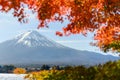 Beautiful view of Fuji san mountain with colorful red maple leaves and winter morning fog in autumn season at lake Kawaguchiko, be Royalty Free Stock Photo
