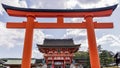 Beautiful view of the Fushimi Inari Shrine in Kyoto, Japan, framed in a red door