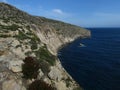 Beautiful view of garigue vegetation growing on coastal limestone cliffs in Maltese Islands Royalty Free Stock Photo