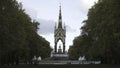 Beautiful view of the golden Albert Memorial surrounded by large green trees in Kensington gardens, London, UK. Action Royalty Free Stock Photo