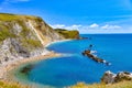 Beautiful view of the green cliffs and blue sea on a sunny day. Lulworth Cove, Dorset, England, UK. Royalty Free Stock Photo