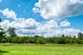 Beautiful view at green grass and dramatic blue sky with clouds Royalty Free Stock Photo