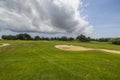 Beautiful view of green grass golf course on island of Aruba against blue sky with white clouds. Royalty Free Stock Photo