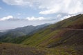 Beautiful view of green mountains with dangerous gravel road. Ketmen or Ketpen mountains gorge and mountain pass.