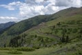 Beautiful view of green mountains with dangerous gravel road. Ketmen or Ketpen mountains gorge and mountain pass.