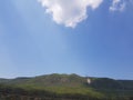 Beautiful view of green mountains and white clouds with blue sky and sunlight outdoor nature photography with mobile phone Royalty Free Stock Photo