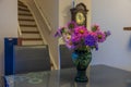 Beautiful view of green vase with colorful asters on grey glass table. Royalty Free Stock Photo