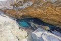 Beautiful view of group of young people swimming in gorge of rocks of Atlantic Ocean on island of Aruba.