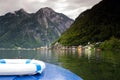 Beautiful View of the Hallstatt from lake Hallstater See, Austria with blue boat on the front popular tourist location Royalty Free Stock Photo