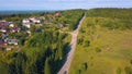 Beautiful view from the helicopter . Clip. A beautiful green summer road near the city, with small residential buildings Royalty Free Stock Photo