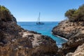 Beautiful view of hidden beach in Mallorca island. Scenic bay witch ship in mediterranean sea