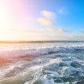 Beautiful View on high waves on the empty coast of the Atlantic Ocean, blue sky with clouds and sunbeam. Deserted Royalty Free Stock Photo