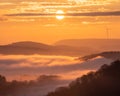 Beautiful view of the hills with a distant wind turbine at sunset Royalty Free Stock Photo