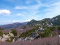 Beautiful view of hills, rocks, green vegatation and forest against blue sky with white clouds Royalty Free Stock Photo