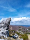 Beautiful view of hills, rocks, green vegatation and forest against blue sky with white clouds Royalty Free Stock Photo