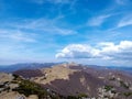 Beautiful view of hills, rocks, green vegatation and forest against blue sky with white clouds Royalty Free Stock Photo