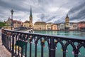 Beautiful view of historic city center of Zurich with famous Fraumunster Church and Munsterbucke crossing river Limmat. Royalty Free Stock Photo