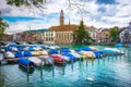 Beautiful view of historic city center of Zurich with famous Fraumunster Church and Munsterbucke crossing river Limmat. Royalty Free Stock Photo